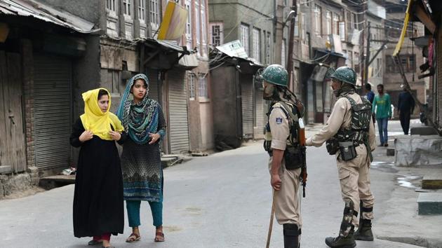 Girls seek permission from security personnel during restrictions imposed in the parts of the Valley following the killing of 2 civilian, in Srinagar on Friday. (PTI Photo) Girls seek permission from security personnel during restrictions imposed in the parts of the Valley following the killing of 2 civilian, in Srinagar on Friday. (PTI Photo)