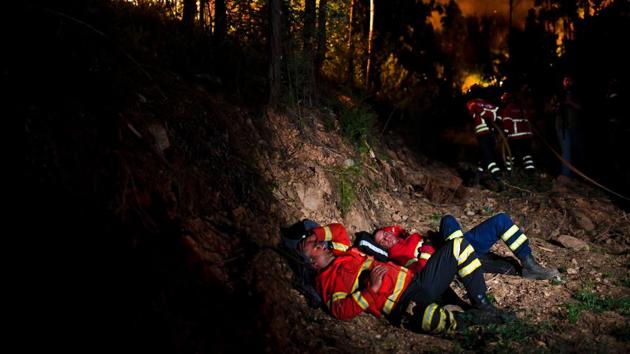 Light rain that started on Monday morning brought only modest relief to the shocked population and exhausted firefighters. (AFP)