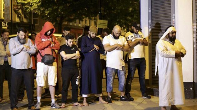 Local people observe prayers at Finsbury Park where a vehicle struck pedestrians in London Monday, June 19. (AP Photo) Local people observe prayers at Finsbury Park where a vehicle struck pedestrians in London Monday, June 19. (AP Photo)