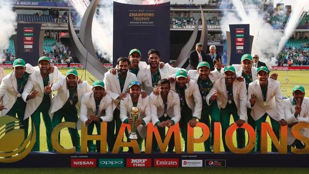 Pakistan players pose with the trophy as they celebrate their win at the presentation after the ICC Champions Trophy final against India at The Oval on Sunday.(AFP)