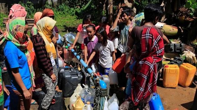 Residents who left their homes to avoid the intense fighting  collect drinking water from an open pipe in southern Philippines.  According to officials, 300 cases of diarrhoea have been recorded among  40,000 people huddled in emergency shelters set up in community halls, gymnasiums and Islamic schools.  (REUTERS) 
