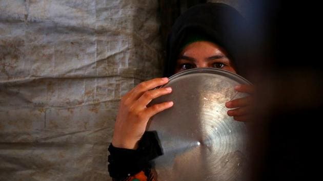 A displaced Syrian woman waits to receive food aid on June 9, 2017 at the al-Mabrouka camp in the village of Ras al-Ain on the Syria-Turkey border, where many Syrians who fled from territory held by the Islamic State (IS) group in Raqa are taking shelter. (AFP) A displaced Syrian woman waits to receive food aid on June 9, 2017 at the al-Mabrouka camp in the village of Ras al-Ain on the Syria-Turkey border, where many Syrians who fled from territory held by the Islamic State (IS) group in Raqa are taking shelter. (AFP)