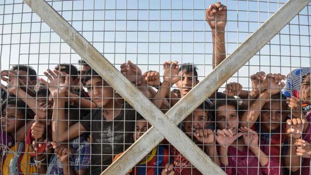Displaced Iraqi children gather behind a fence at the Hasan Sham camp for internally displaced people. According to a new report by the United Nations High Commissioner for Refugees (UNHCR), a record 65.6 million people worldwide were forcibly displaced from their homes due to conflict or persecution by the end of 2016. The number marks a jump of 300,000 from the end of 2015. ‘This equates to one person becoming displaced every three seconds - less than the time it takes to read this sentence’ the United Nations report said. (AFP) Displaced Iraqi children gather behind a fence at the Hasan Sham camp for internally displaced people. According to a new report by the United Nations High Commissioner for Refugees (UNHCR), a record 65.6 million people worldwide were forcibly displaced from their homes due to conflict or persecution by the end of 2016. The number marks a jump of 300,000 from the end of 2015. ‘This equates to one person becoming displaced every three seconds - less than the time it takes to read this sentence’ the United Nations report said. (AFP)