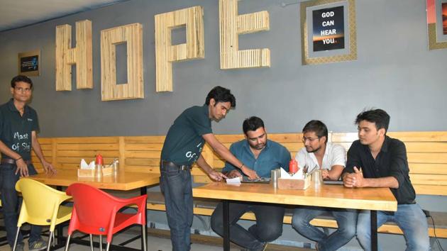 Hearing impaired waiters serve at the eatery in Jaipur.(Prabhakar Sharma/HT)