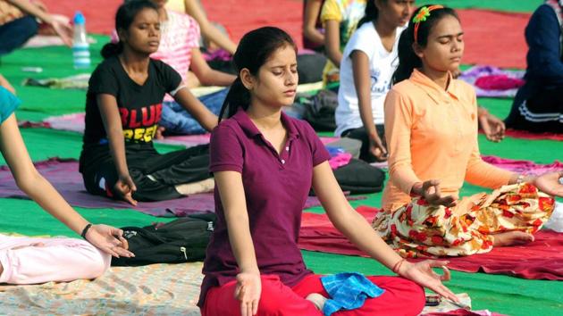 Students practice yoga ahead of the third International Yoga day on June 21 at Parade Ground in Allahabad on Saturday. (PTI Photo) Students practice yoga ahead of the third International Yoga day on June 21 at Parade Ground in Allahabad on Saturday. (PTI Photo)