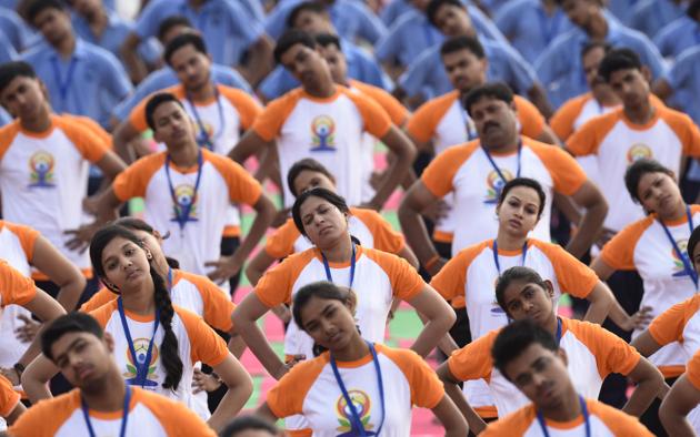 Nearly 51000 people take part in the Full Dress Rehearsal practising asanas at Ramabai Ambedkar Maidan ahead of the 2017 International Yoga Day, on June 19, 2017 in Lucknow, Uttar Pradesh. Lucknow plans a massive showcase of Yoga with preparations underway for the presence of Prime Minister Narendra Modi and Uttar Pradesh Chief Minister Yogi Adityanath at the event. Special arrangements for participants and an elaborate security perimeter for the visit of high-ranking politicians are also underway.(Subhankar Chakraborty/HT PHOTO)