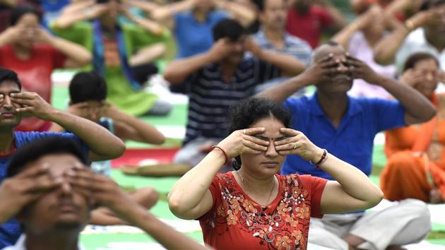 People perform yoga at Lodhi Garden in New Delhi in preparation for the International Yoga Day on June 21, 2017. (Arvind Yadav/HT PHOTO) People perform yoga at Lodhi Garden in New Delhi in preparation for the International Yoga Day on June 21, 2017. (Arvind Yadav/HT PHOTO)
