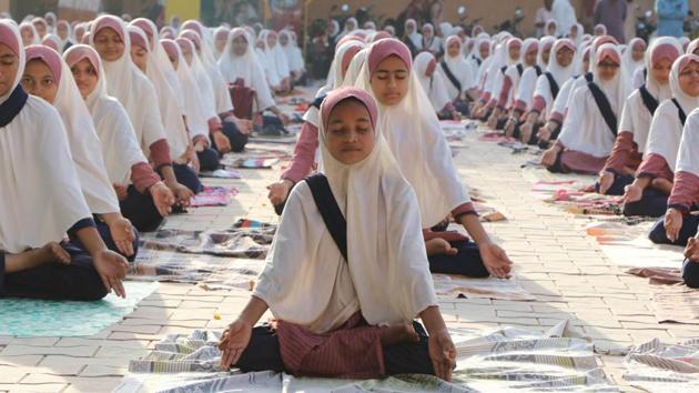 Students practice yoga ahead of International Yoga Day at a school in Ahmedabad, Gujarat on June 17, 2017. Yoga is being promoted by the Permanent Mission of India to the UN as a holistic means of promoting mental and physical wellbeing. The ancient practice which originated in India, has followers taking to their mats all over the world. As a nod to this global appeal of yoga, the UN observes June 21 as International Day of Yoga. Here’s how India’s been getting it’s asanas down pat. (Siddharaj Solanki/HT Photo) Students practice yoga ahead of International Yoga Day at a school in Ahmedabad, Gujarat on June 17, 2017. Yoga is being promoted by the Permanent Mission of India to the UN as a holistic means of promoting mental and physical wellbeing. The ancient practice which originated in India, has followers taking to their mats all over the world. As a nod to this global appeal of yoga, the UN observes June 21 as International Day of Yoga. Here’s how India’s been getting it’s asanas down pat. (Siddharaj Solanki/HT Photo)