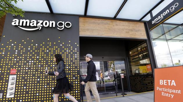 People walk past an Amazon Go store, currently open only to Amazon employees, in Seattle. Amazon Go shops are convenience stores that don't use cashiers or checkout lines, but use a tracking system that of sensors, algorithms, and cameras to determine what a customer has bought.(AP file photo)