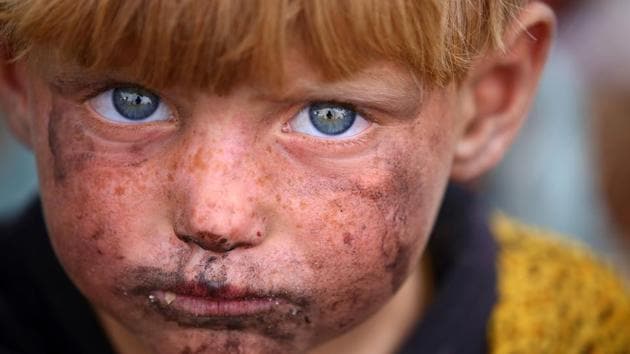 A displaced Syrian child who fled the countryside surrounding the Islamic State (IS) group stronghold of Raqa, at a temporary camp in the village of Ain Issa. (AFP)