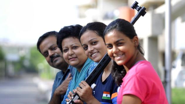 Shreya Saksena (holding a rifle) with her family in Greater Noida. (Sunil Ghosh/HT Photo) Shreya Saksena (holding a rifle) with her family in Greater Noida. (Sunil Ghosh/HT Photo)
