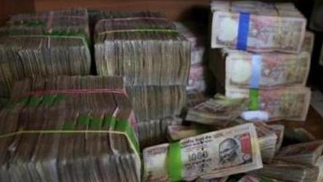 Discontinued currency notes of 1,000 denomination seen after they were deposited by people at a bank in Bangalore. (AP File Photo) Discontinued currency notes of 1,000 denomination seen after they were deposited by people at a bank in Bangalore. (AP File Photo)