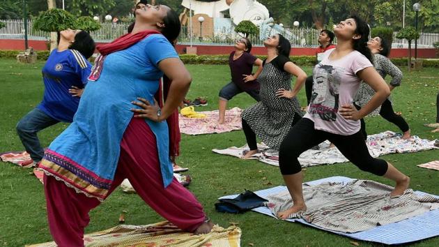 People practice yoga at a park in Lucknow, Uttar Pradesh on June 18, 2017. (Nand Kumar/PTI) People practice yoga at a park in Lucknow, Uttar Pradesh on June 18, 2017. (Nand Kumar/PTI)