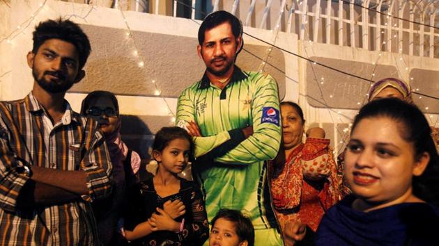 Fans pose with a picture of Sarfraz Ahmed, the captain who helped Pakistan secure the treble of ICC Championship trophies. (REUTERS) Fans pose with a picture of Sarfraz Ahmed, the captain who helped Pakistan secure the treble of ICC Championship trophies. (REUTERS)