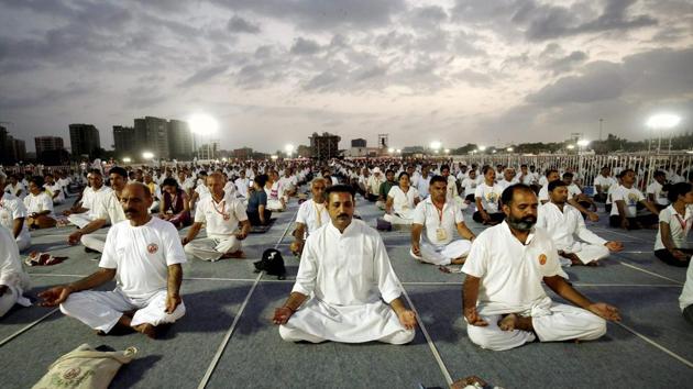 People practice asanas during a mass yoga session on the third day of Baba Ramdev Yoga camp in Ahmedabad, Gujarat on June 20, 2017. (PTI) People practice asanas during a mass yoga session on the third day of Baba Ramdev Yoga camp in Ahmedabad, Gujarat on June 20, 2017. (PTI)
