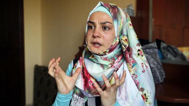 Alaa, 19, who was shot in her jaw during a clashes between the Syrian government forces and the rebels gestures as she tells her story. (AP)