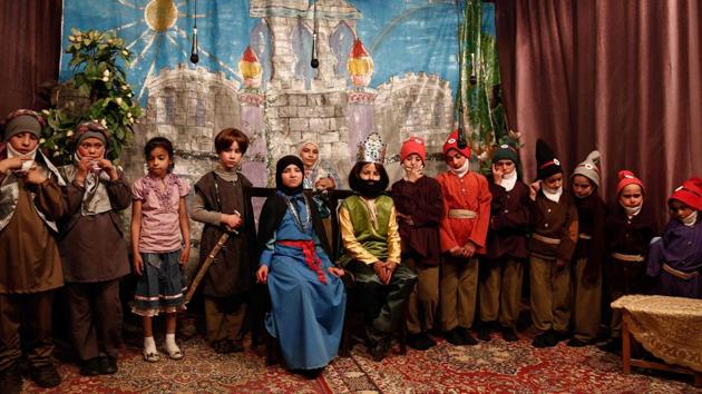 A group picture shows Syrian girl actors posing after performing an English-language school play adaptation of Snow White and the Seven Dwarfs. To escape the nightmare of life in their besieged home town near Syria's capital, 13 young girls sought refuge in a fairytale performance of Snow White and the Seven Dwarfs. (AFP)