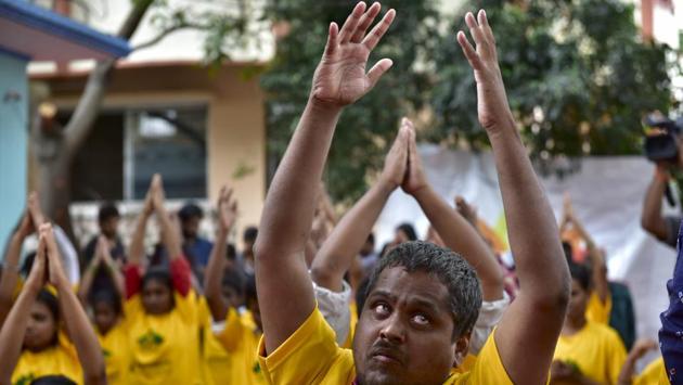 Visually challenged people perform yoga at a camp on the eve of International Yoga Day in Bengaluru, Karnataka on June 20, 2017. (Arijit Sen/HT Photo) Visually challenged people perform yoga at a camp on the eve of International Yoga Day in Bengaluru, Karnataka on June 20, 2017. (Arijit Sen/HT Photo)