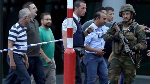 Soldiers and police officials guide members of the public from inside a cordoned off area on a street outside Gare Centrale in Brussels on June 20, 2017, after an explosion in the Belgian capital. (AFP) Soldiers and police officials guide members of the public from inside a cordoned off area on a street outside Gare Centrale in Brussels on June 20, 2017, after an explosion in the Belgian capital. (AFP)