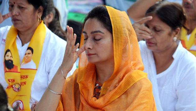 Union food processing minister Harsimrat Kaur Badal performing Anulom Vilom Pranayam at a yoga event in Bathinda. (Sanjeev Kumar/HT) Union food processing minister Harsimrat Kaur Badal performing Anulom Vilom Pranayam at a yoga event in Bathinda. (Sanjeev Kumar/HT)