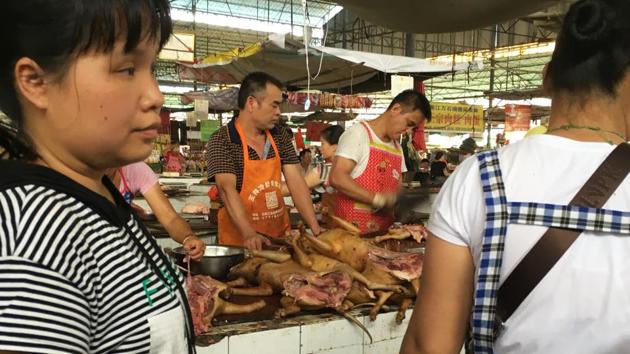 Vendors stand behind a pile of dog meat at the Nanqiao market in Yulin, China. According to Human Society International(HSI) reports 10 million to 20 million dogs are killed for food annually in China. (AFP) Vendors stand behind a pile of dog meat at the Nanqiao market in Yulin, China. According to Human Society International(HSI) reports 10 million to 20 million dogs are killed for food annually in China. (AFP)