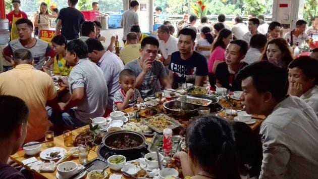 People eat dog meat at a restaurant in Yulin on the opening day of the dog meat festival. (AFP) People eat dog meat at a restaurant in Yulin on the opening day of the dog meat festival. (AFP)