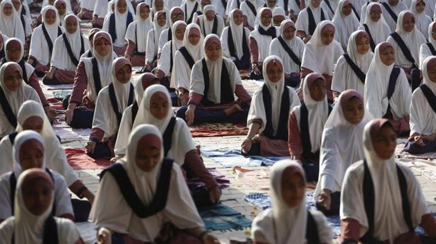 Muslim students practice yoga as part of International Yoga Day celebrations at a school in Ahmedabad in Gujarat.(AP)