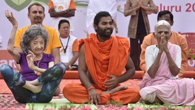 (L-R) World's oldest Yoga teacher, 98-and-a-half years old Tao Porchon-Lynch, Swamy Vachananandaji and India's oldest Yoga teacher 98-year-old Amma Nannamal during Iternational Day of Yoga at Kanteerava Stadium in Bengaluru, Karnataka. (Arijit Sen/HT Photo) (L-R) World's oldest Yoga teacher, 98-and-a-half years old Tao Porchon-Lynch, Swamy Vachananandaji and India's oldest Yoga teacher 98-year-old Amma Nannamal during Iternational Day of Yoga at Kanteerava Stadium in Bengaluru, Karnataka. (Arijit Sen/HT Photo)