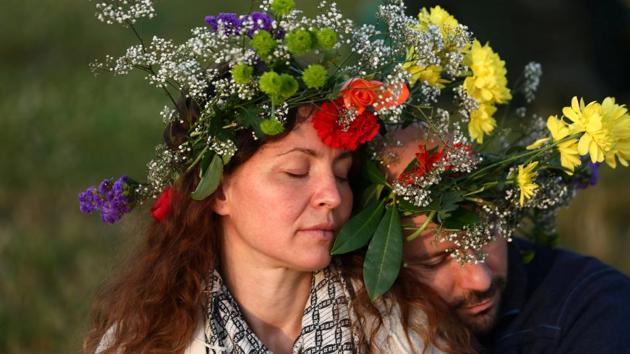A couple hold each other as they welcome the rising sun on the Stonehenge monument. (REUTERS)