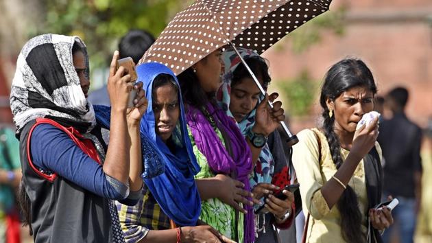People use scarves and umbrellas to keep the sun away on a hot day in Delhi. (Sonu Mehta/HT PHOTO) People use scarves and umbrellas to keep the sun away on a hot day in Delhi. (Sonu Mehta/HT PHOTO)