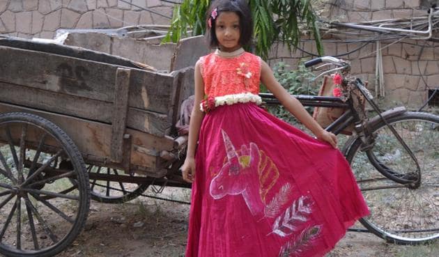 A child sports clothes painted and donated by 19-year-old Aanchal Sewani.