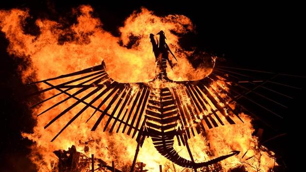 A bonfire featuring a large wooden phoenix burns at the Glastonbury Festival in Somerset, England. (AFP) A bonfire featuring a large wooden phoenix burns at the Glastonbury Festival in Somerset, England. (AFP)