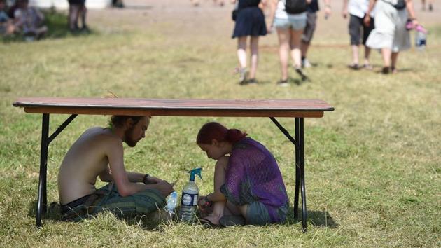 Revellers shelter from the sun as they attend the Glastonbury Festival of Music and Performing Arts on Worthy Farm near the village of Pilton in Somerset, England. (AFP) Revellers shelter from the sun as they attend the Glastonbury Festival of Music and Performing Arts on Worthy Farm near the village of Pilton in Somerset, England. (AFP)