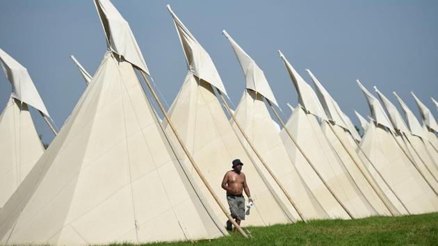 A revellers walks past tipi tents at the Glastonbury Festival of Music and Performing Arts on Worthy Farm near the village of Pilton in Somerset,England. (AFP) A revellers walks past tipi tents at the Glastonbury Festival of Music and Performing Arts on Worthy Farm near the village of Pilton in Somerset,England. (AFP)