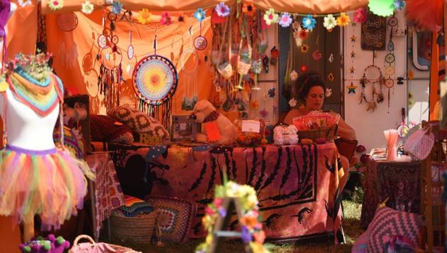 A woman waits to receive customers on her stall at the festival in England. (AFP) A woman waits to receive customers on her stall at the festival in England. (AFP)