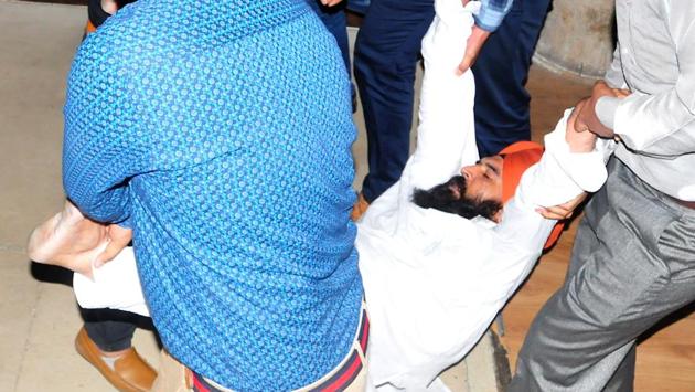 AAP MLA Jai Kishan Singh being removed by Punjab Vidhan Sabha staff in Chandigarh on Thursday. (Sanjeev Sharma/HT Photo) AAP MLA Jai Kishan Singh being removed by Punjab Vidhan Sabha staff in Chandigarh on Thursday. (Sanjeev Sharma/HT Photo)