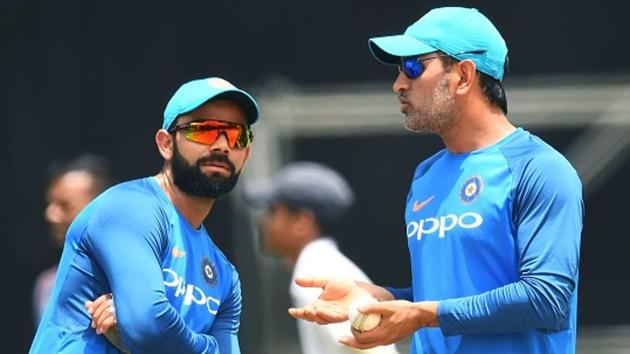 India's captain Virat Kohli (L) listens to teammate MS Dhoni during a practice session at the Queen's Park Oval in Port of Spain, Trinidad. (AFP/Getty Images)