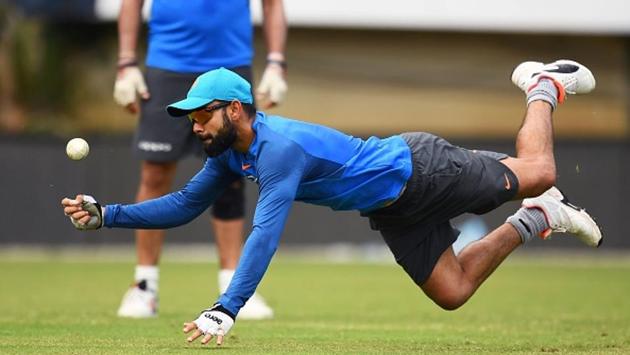 India's captain Virat Kohli dives to field a ball. (AFP/Getty Images)