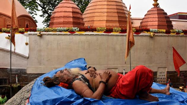 A Sadhu or a Hindu holy man sleeps inside the Kamakhya temple during the annual Hindu festival of Ambubachi. (REUTERS) A Sadhu or a Hindu holy man sleeps inside the Kamakhya temple during the annual Hindu festival of Ambubachi. (REUTERS)