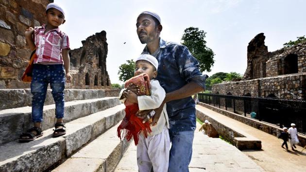 A man helps a child carrying a prayer mat up the steps of the Firoz Shah Kotla mosque on June 23, 2017 in New Delhi. (Arun Sharma/HT PHOTO) A man helps a child carrying a prayer mat up the steps of the Firoz Shah Kotla mosque on June 23, 2017 in New Delhi. (Arun Sharma/HT PHOTO)