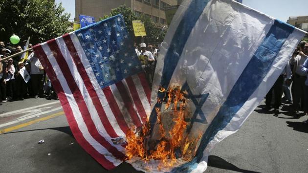 Iranian protesters burn representations of US and Israeli flags in their annual pro-Palestinian rally marking Al-Quds (Jerusalem) Day in Tehran, Iran, Friday, June 23, 2017. Iran held rallies across the country, with protesters condemning Israel's occupation of Palestinian territories and chanting "Death to Israel."(AP Photo)