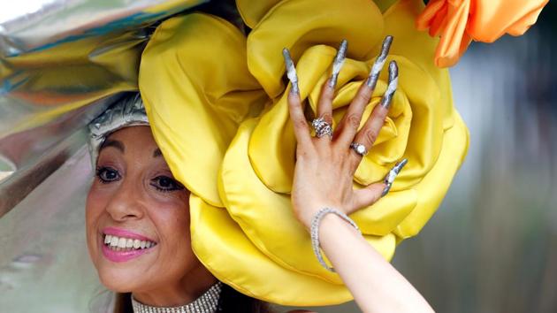 Guests glammed up for the stylish day of racing, with men dressed in top hats and tails, while women wowed in summer-appropriate dresses. (Action Images via Reuters) Guests glammed up for the stylish day of racing, with men dressed in top hats and tails, while women wowed in summer-appropriate dresses. (Action Images via Reuters)