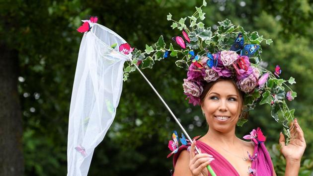 A racegoer wearing a hot pink ornate dress that was adorned with a garden-inspired hat (Toby Melville / Reuters) A racegoer wearing a hot pink ornate dress that was adorned with a garden-inspired hat (Toby Melville / Reuters)