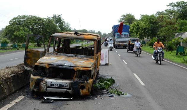 A vehicle damaged in Thursday’s protests on the road leading to Nevali near Mumbai