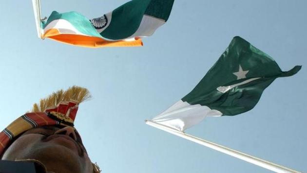 Border guard stands near Indian and Pakistani flags during a fair at Chamliyal in Jammu and Kashmir. (Reuters File Photo) Border guard stands near Indian and Pakistani flags during a fair at Chamliyal in Jammu and Kashmir. (Reuters File Photo)