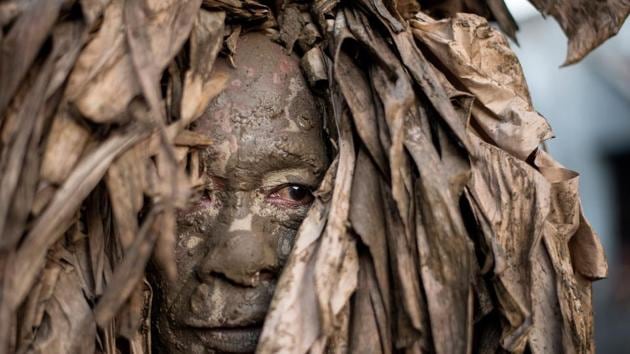 A devotee wearing a costume made of banana leaves heads to church to attend mass as part of a religious festival, in honor of St. John the Baptist, also known locally as the ‘mud people’ festival, in Aliaga town, Nueva Ecija province, north of Manila. The Feast Day of St John the Baptist is celebrated in the Philippines every year. (Noel Celis / AFP) A devotee wearing a costume made of banana leaves heads to church to attend mass as part of a religious festival, in honor of St. John the Baptist, also known locally as the ‘mud people’ festival, in Aliaga town, Nueva Ecija province, north of Manila. The Feast Day of St John the Baptist is celebrated in the Philippines every year. (Noel Celis / AFP)