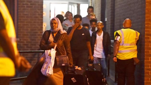 Residents are evacuated from the Taplow Tower residential block as a precautionary measure following concerns over the type of cladding used on the outside of the building on the Chalcots Estate in north London, Britain, June 23, 2017. (REUTERS) Residents are evacuated from the Taplow Tower residential block as a precautionary measure following concerns over the type of cladding used on the outside of the building on the Chalcots Estate in north London, Britain, June 23, 2017. (REUTERS)