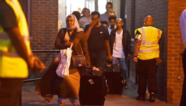 Residents are evacuated from the Taplow Tower residential block as a precautionary measure following concerns over the type of cladding used on the outside of the building on the Chalcots Estate in north London. (Reuters photo) Residents are evacuated from the Taplow Tower residential block as a precautionary measure following concerns over the type of cladding used on the outside of the building on the Chalcots Estate in north London. (Reuters photo)