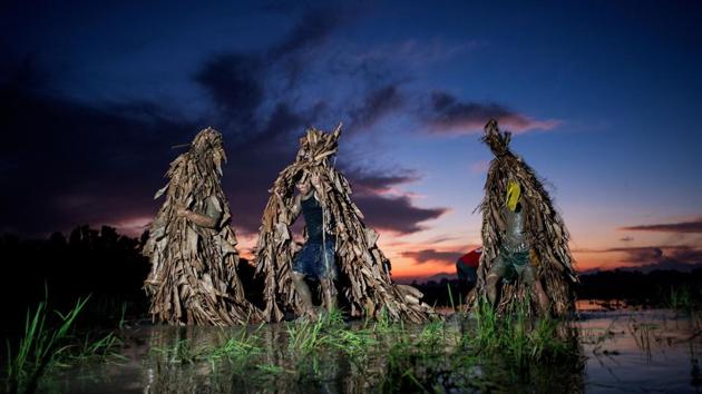 In the village of Bibiclat in Nueva Ecija province, people transform themselves into ‘taong putik’ (mud people) by covering themselves in mud and wearing costumes made from dried banana leaves. The village’s “Taong Putik” or mud people festival dates back to the Japanese occupation of the Philippines in the 1940s, according to the village chief, Norberto Eugenio. (Noel Celis / AFP) In the village of Bibiclat in Nueva Ecija province, people transform themselves into ‘taong putik’ (mud people) by covering themselves in mud and wearing costumes made from dried banana leaves. The village’s “Taong Putik” or mud people festival dates back to the Japanese occupation of the Philippines in the 1940s, according to the village chief, Norberto Eugenio. (Noel Celis / AFP)