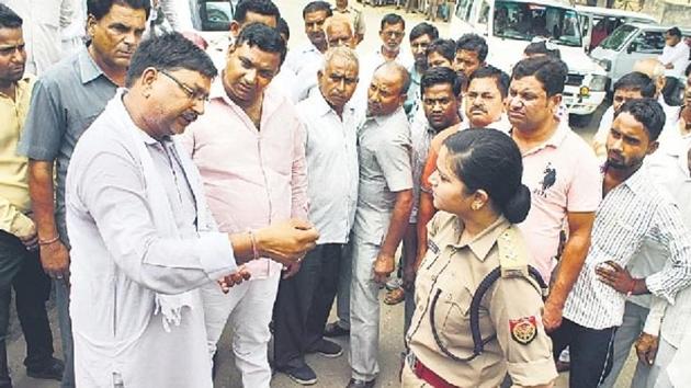 Police officer Shrestha Thakur standing her ground against BJP protesters at the district court compound in Bulandshahr on Friday.(HT Photo)